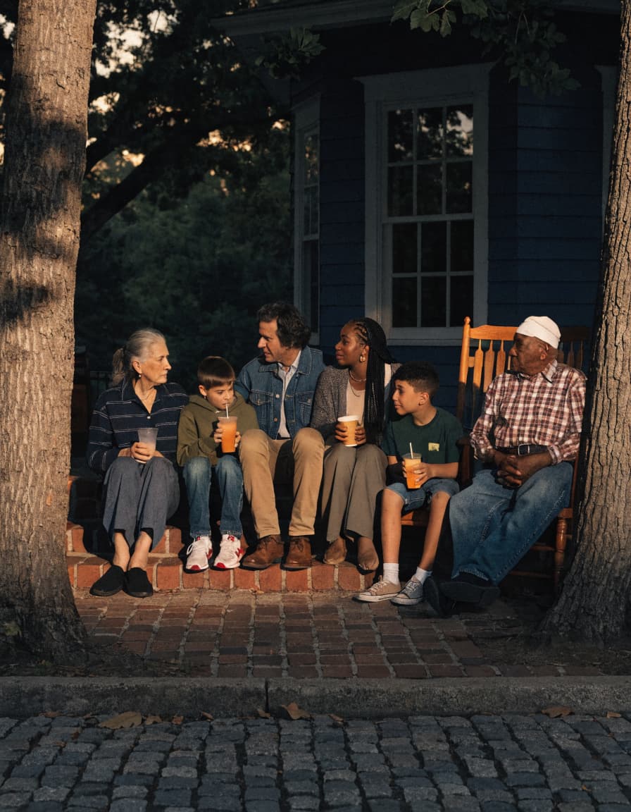 A family gathered outdoors in a Georgia neighborhood at evening